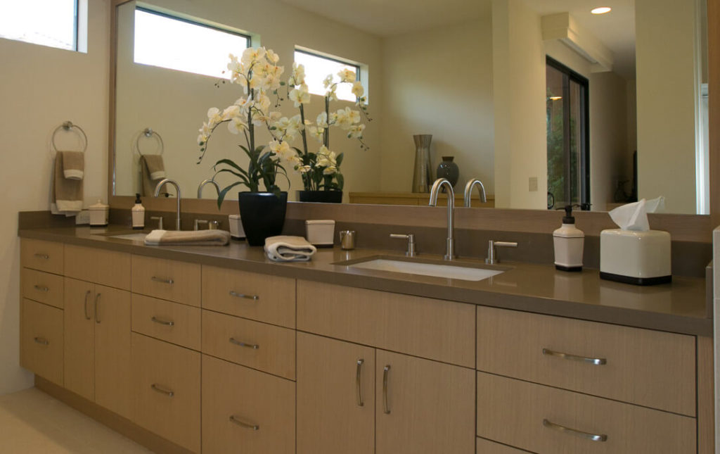 A beautiful, contemporary bathroom remodel with maple, Euro-style cabinetry and caramel-colored countertops