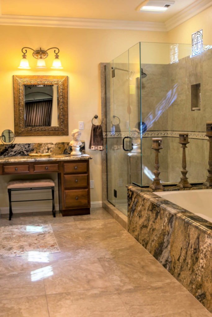 Elegant bathroom remodel with glass shower surround and contrasting color stone
