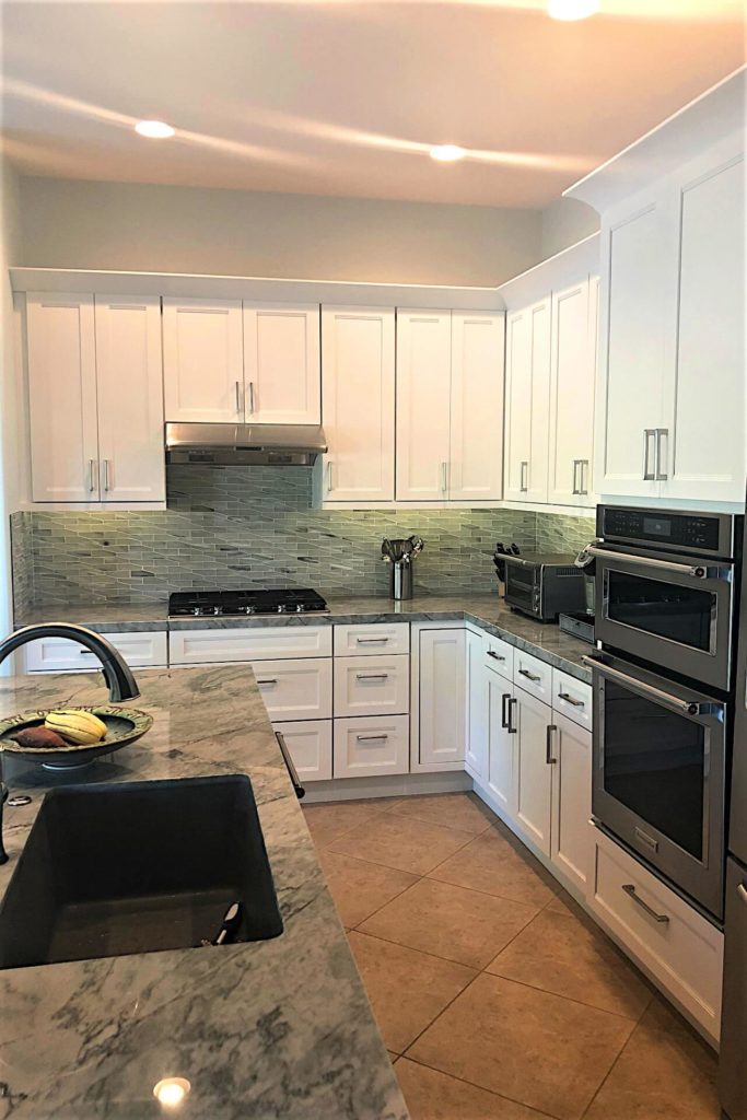 Shaker style kitchen cabinets with white finish